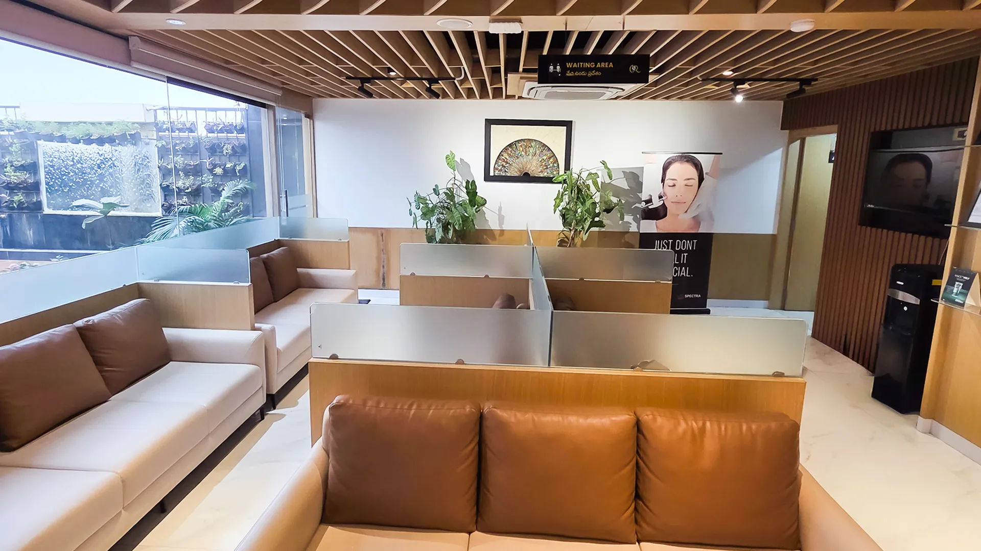 Row of private patient waiting booths with frosted glass privacy shields